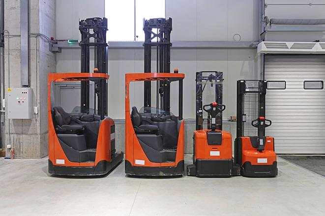 forklift driver operating equipment in a storage facility